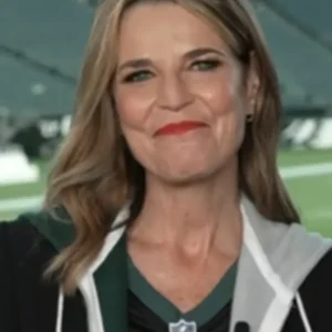 Savannah Guthrie, co-host of the Today Show, has always talked about how much she loves sports and fashion. She garnered attention in 2025 when she wore the stylish black Philadelphia Eagles jersey during a show segment. Her fans loved how she wore casual sportswear with smart fashion to support the Eagles in a stylish way. Whether you are an Eagles or Savannah fan, this jersey offers the perfect mix of comfort and celebrity-inspired style. The Savannah Guthrie Black Philadelphia Eagles Jersey is made of a durable and soft blend of cotton and polyester, making it perfect for game day or casual get-togethers. It features a classic V-neck collar and an easy-to-wear pullover style. The loose fit offered by the short sleeves and open hem cuffs will keep you comfortable and cool. The printed front proudly displays your team support, and the black color makes it look sleek and bold. Whether they are attending a tailgate party, watching the game at home, or just wanting to look athletic, this jersey is a must-have for any Philadelphia Eagles fan.